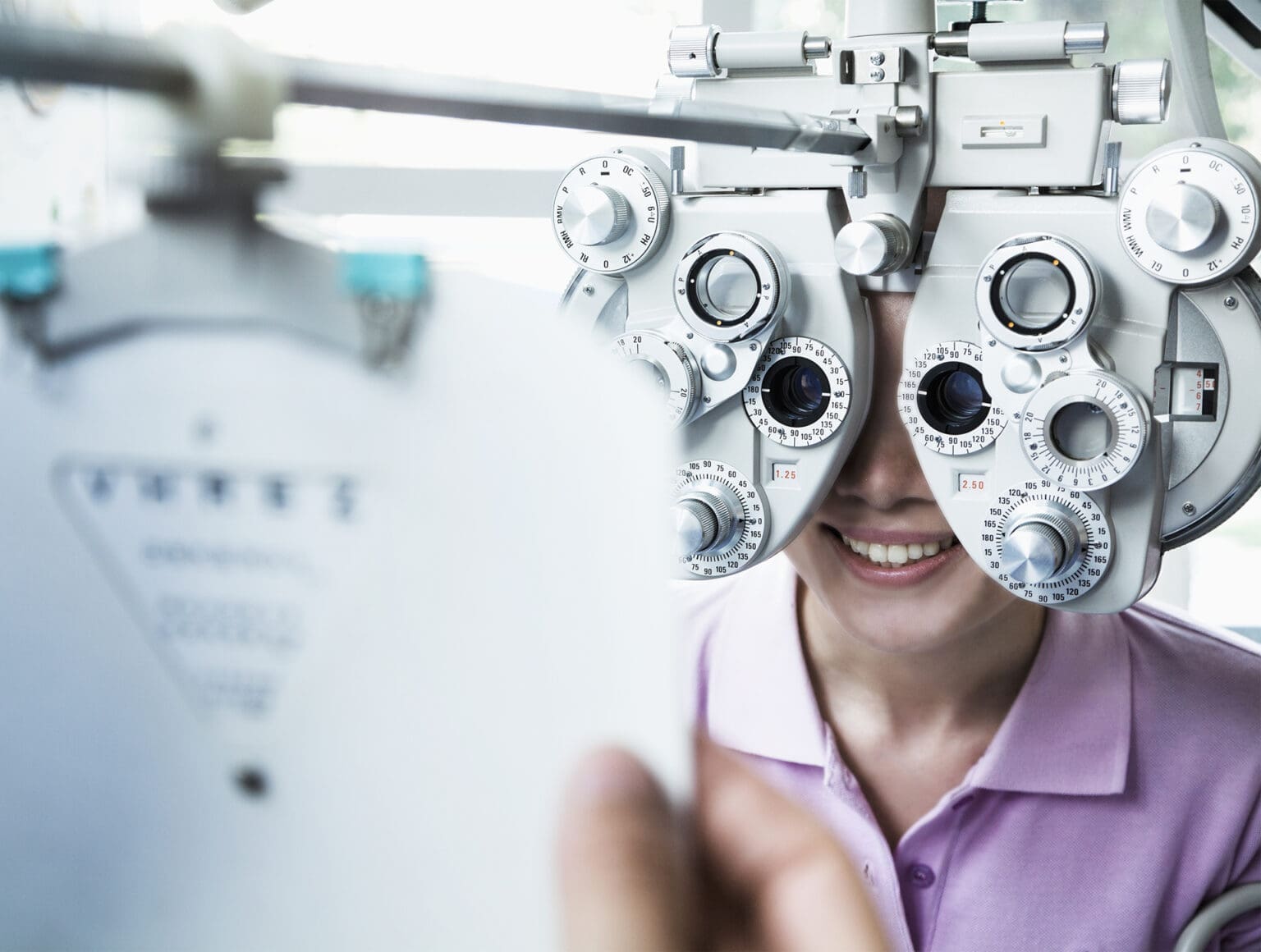 Optometrist doing an eye exam on a patient