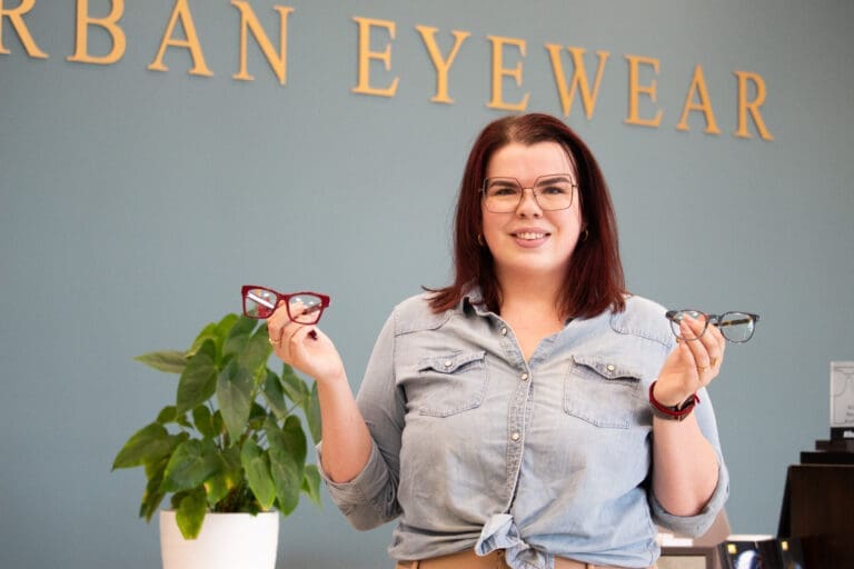 Urban Eyewear Employee Holding Glasses