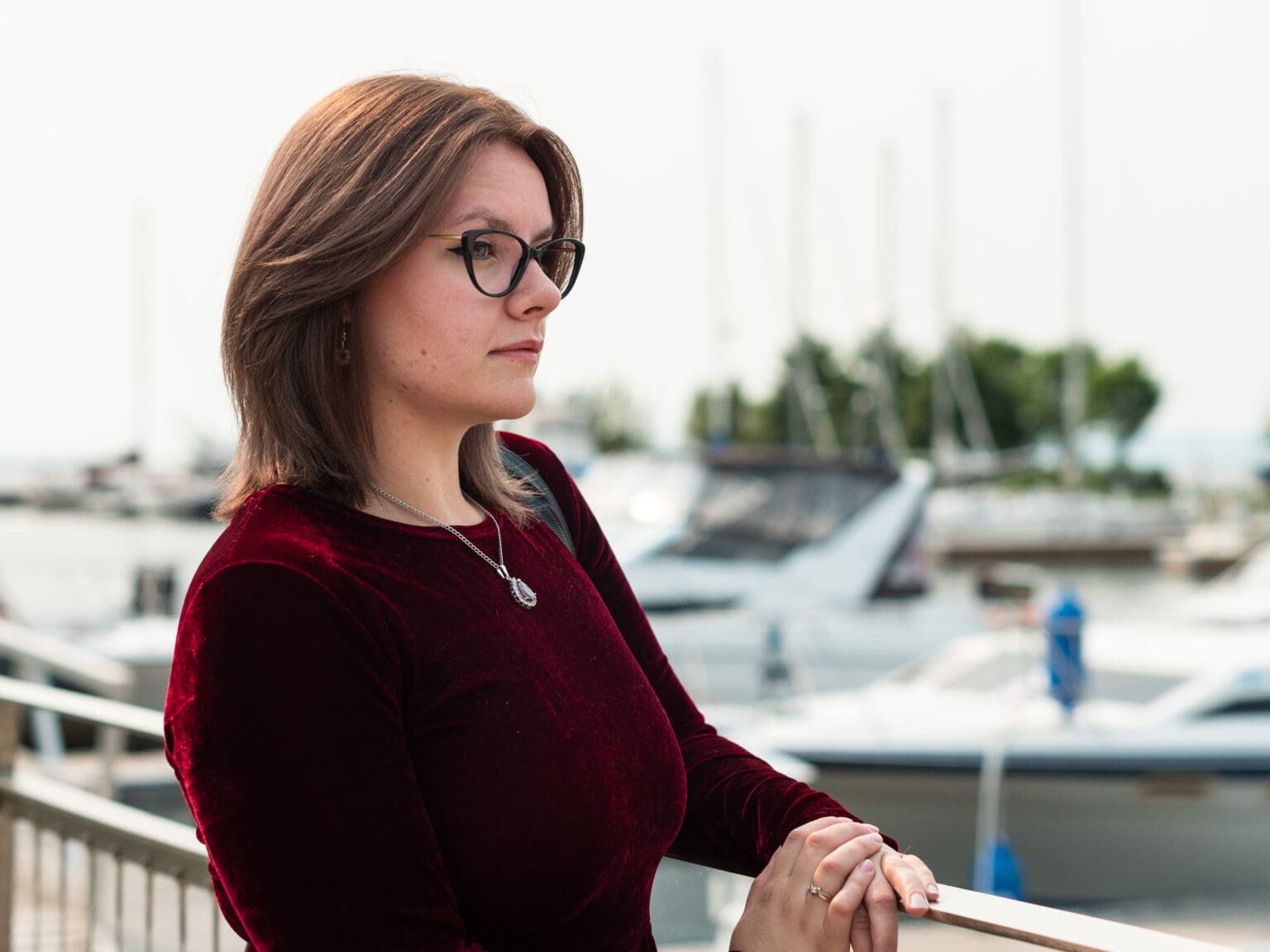 Woman standing at Marina Park in Thunder Bay wearing glasses